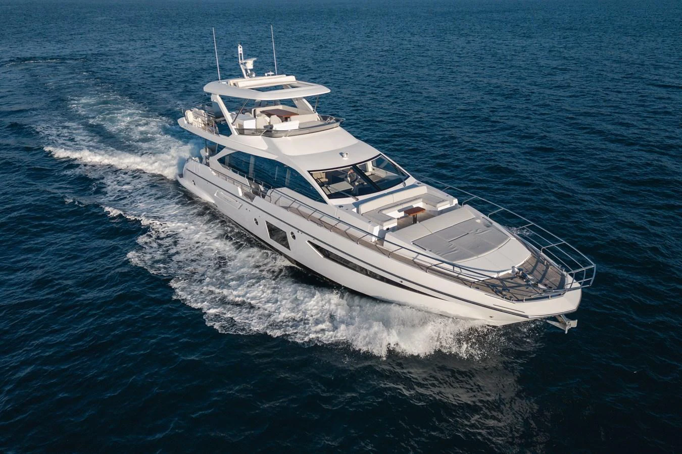 A sleek and modern yacht cruises through the open sea, showcasing its elegant design and spacious decks. aboard HELSIE SI Yacht for Sale