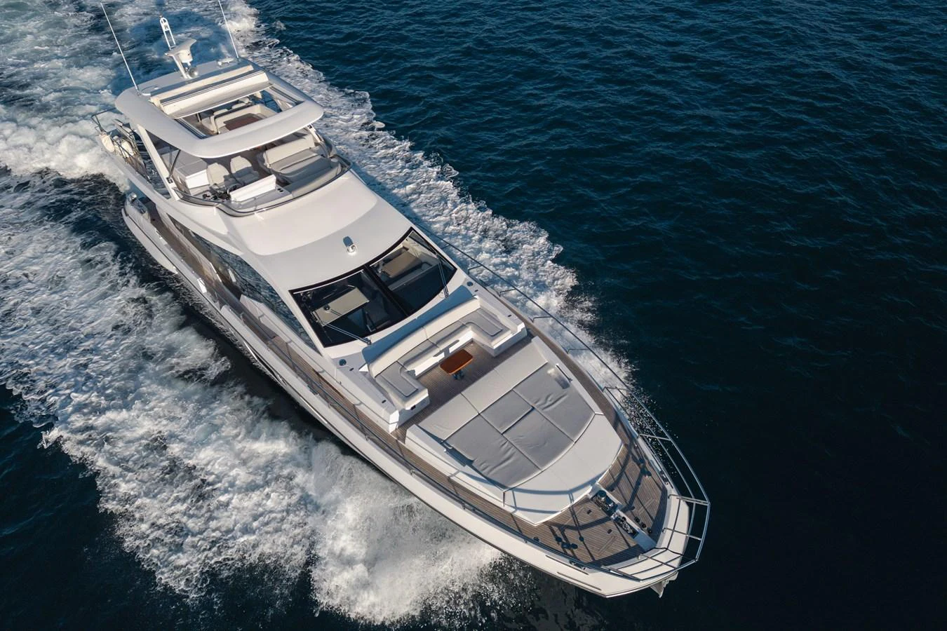 A sleek and modern yacht cruising through the open water, showcasing its elegant design and spacious deck areas. aboard HELSIE SI Yacht for Sale