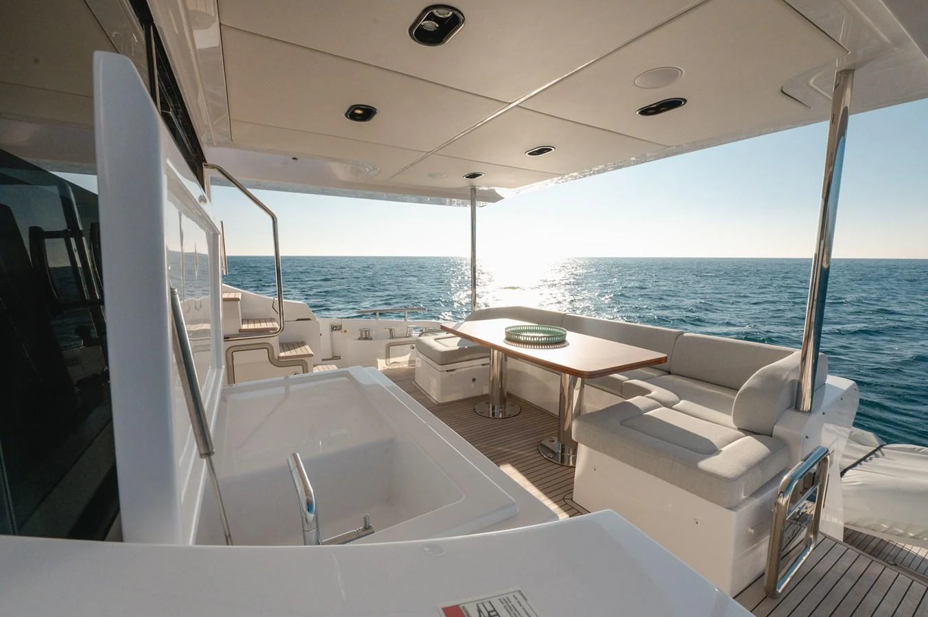 The aft deck offers a spacious and inviting area for relaxation and dining with stunning ocean views. aboard HELSIE SI Yacht for Sale