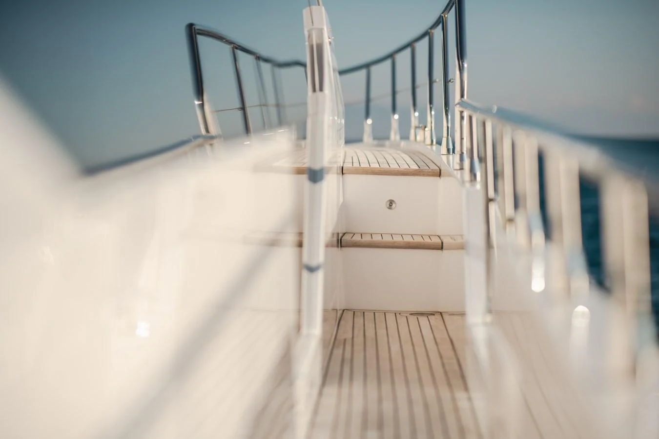 A close-up view of the yacht's side deck with wooden steps leading up. aboard HELSIE SI Yacht for Sale