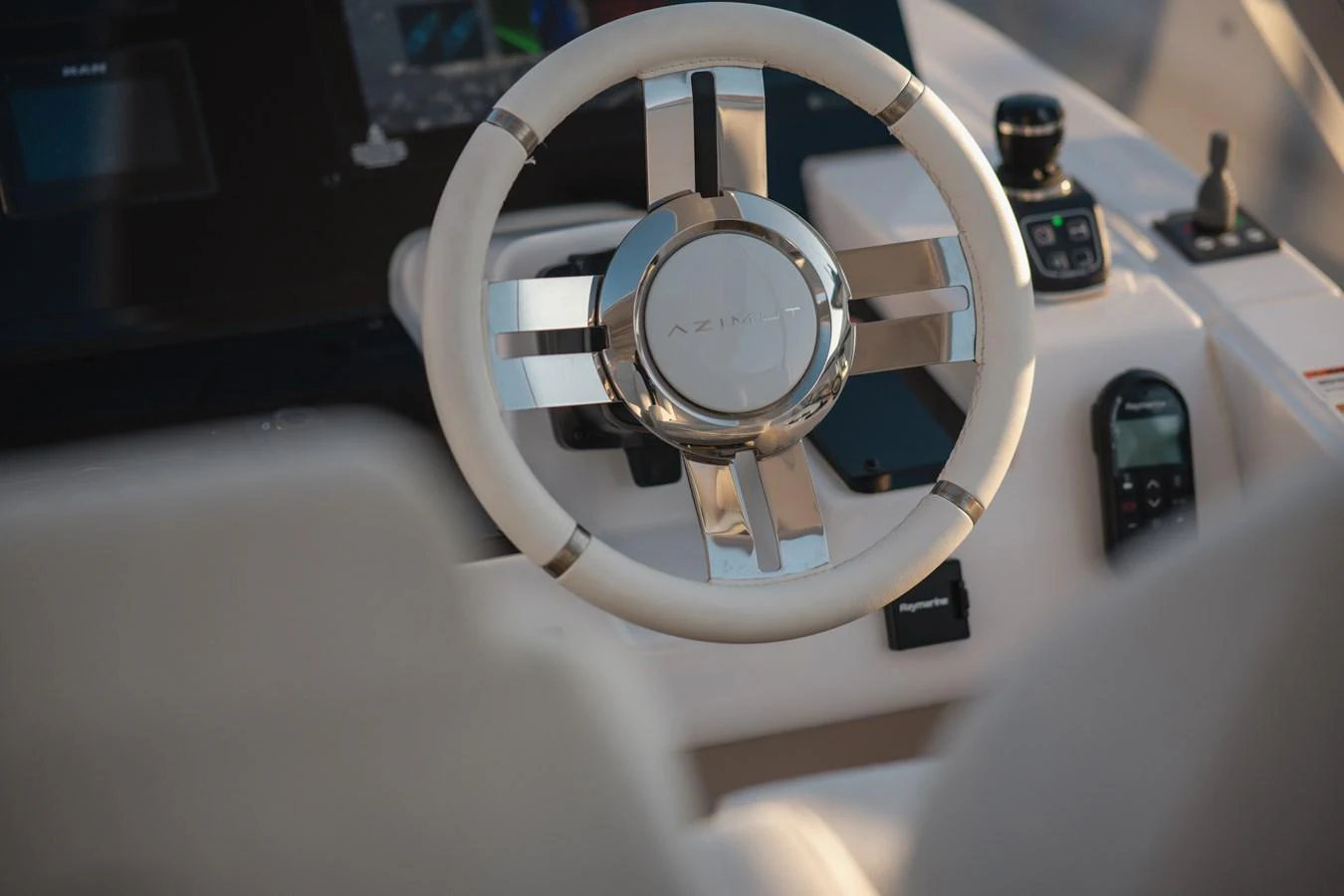 A close-up view of the yacht's helm showcasing the steering wheel and control instruments. aboard HELSIE SI Yacht for Sale