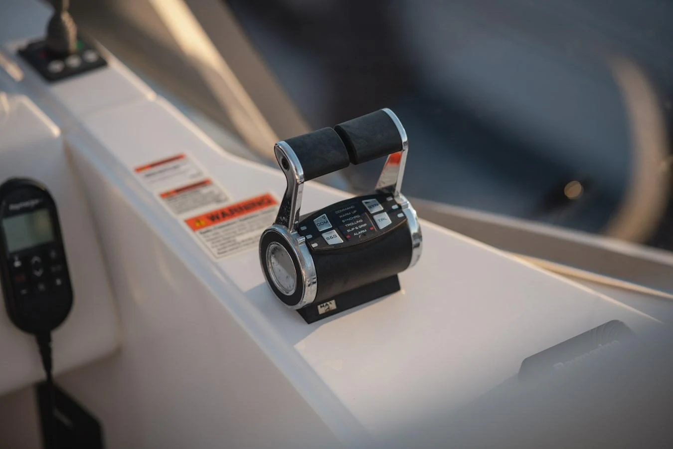 A close-up of the yacht's throttle control at the helm station. aboard HELSIE SI Yacht for Sale