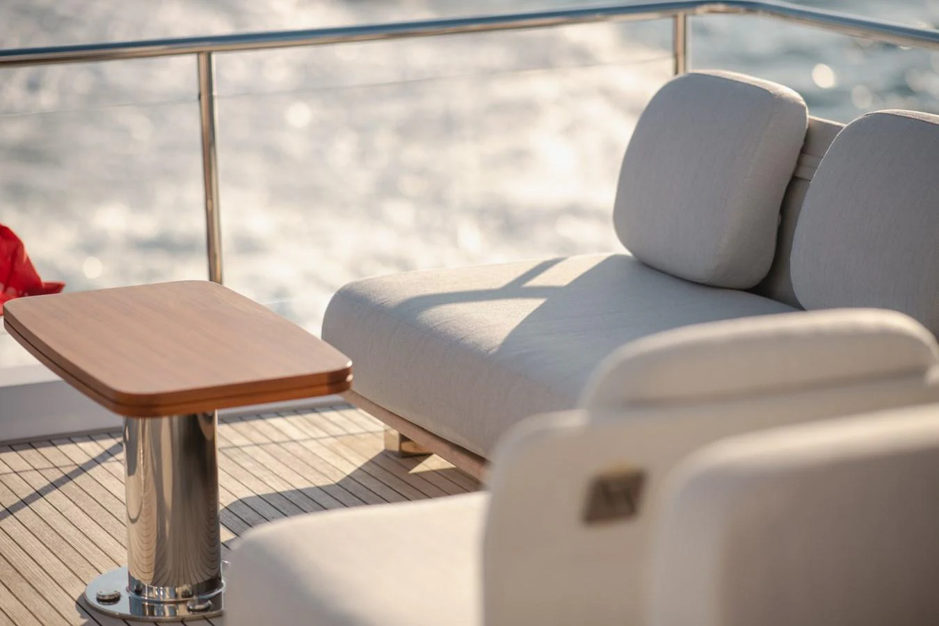 The sundeck features plush seating and a sleek wooden table, perfect for relaxation while enjoying the ocean view. aboard HELSIE SI Yacht for Sale