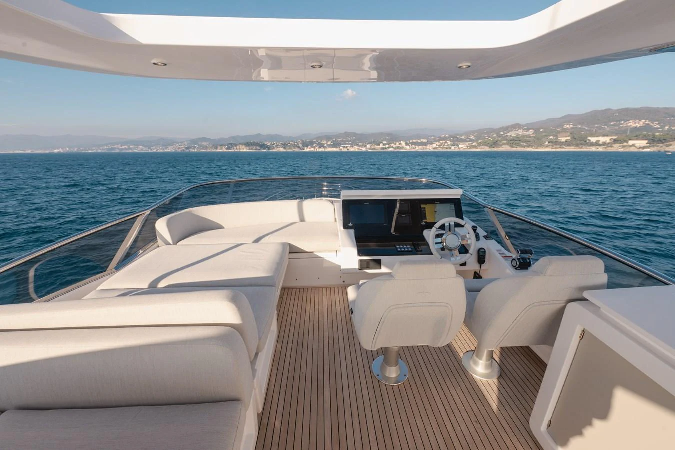 The flybridge offers a luxurious and spacious area with comfortable seating and a modern helm station. aboard HELSIE SI Yacht for Sale