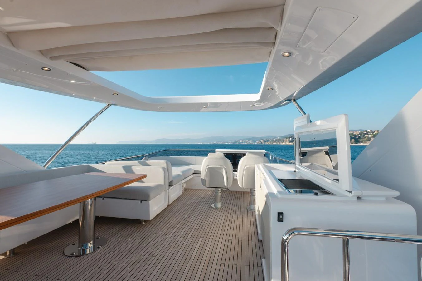 The flybridge offers a spacious and luxurious outdoor area with ample seating and stunning ocean views. aboard HELSIE SI Yacht for Sale