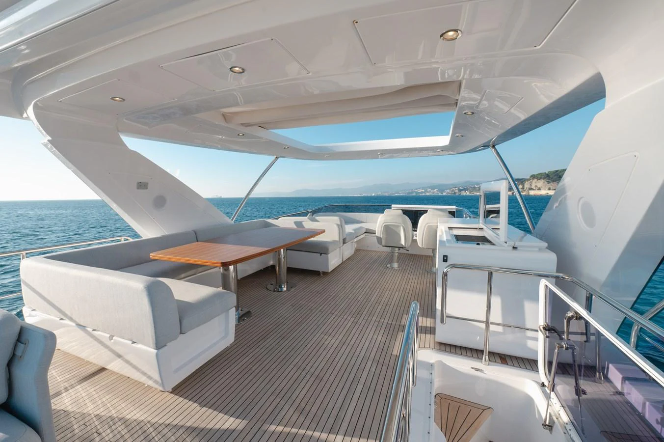 The flybridge offers a spacious and luxurious outdoor seating area with stunning ocean views. aboard HELSIE SI Yacht for Sale