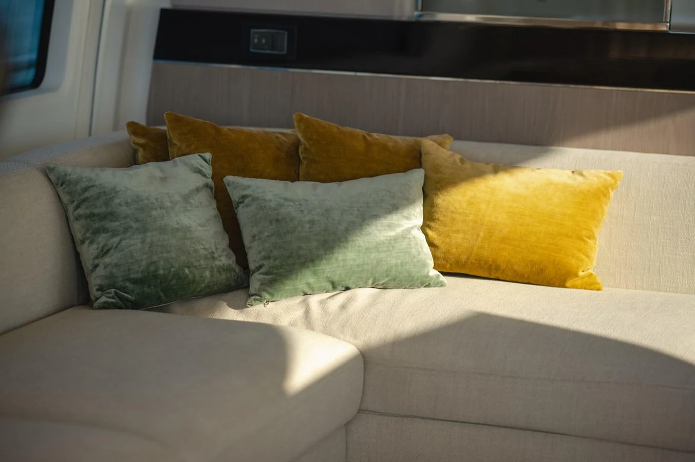 The image showcases a cozy seating area with plush cushions in a yacht's interior. aboard HELSIE SI Yacht for Sale
