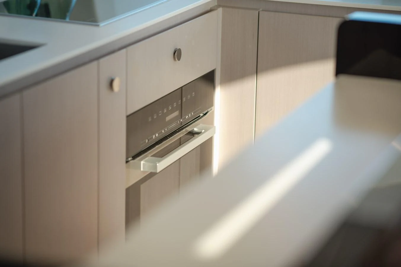 The image showcases a modern galley with sleek cabinetry and built-in appliances. aboard HELSIE SI Yacht for Sale