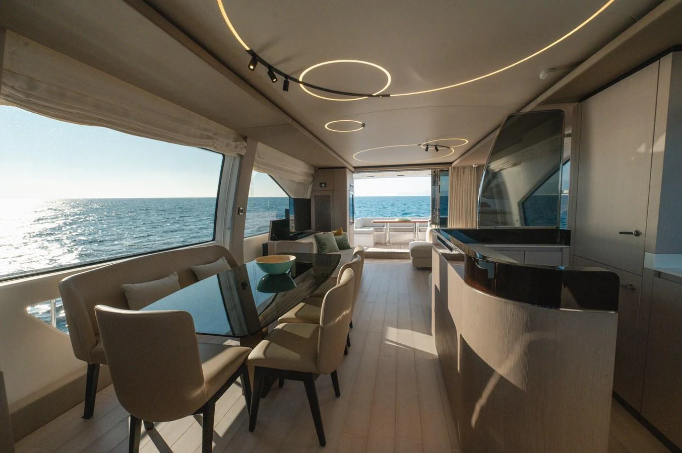 The yacht's salon features elegant dining and lounging areas with panoramic ocean views. aboard HELSIE SI Yacht for Sale