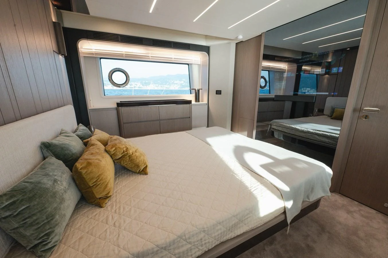 The stateroom features a comfortable bed with plush pillows and a large window offering scenic views. aboard HELSIE SI Yacht for Sale