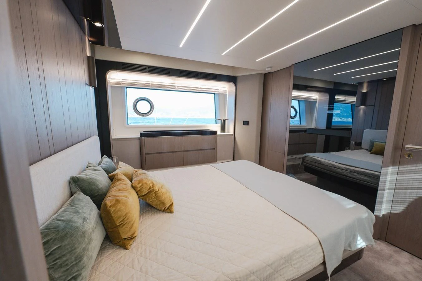 The stateroom features a luxurious bed with plush pillows and modern lighting. aboard HELSIE SI Yacht for Sale