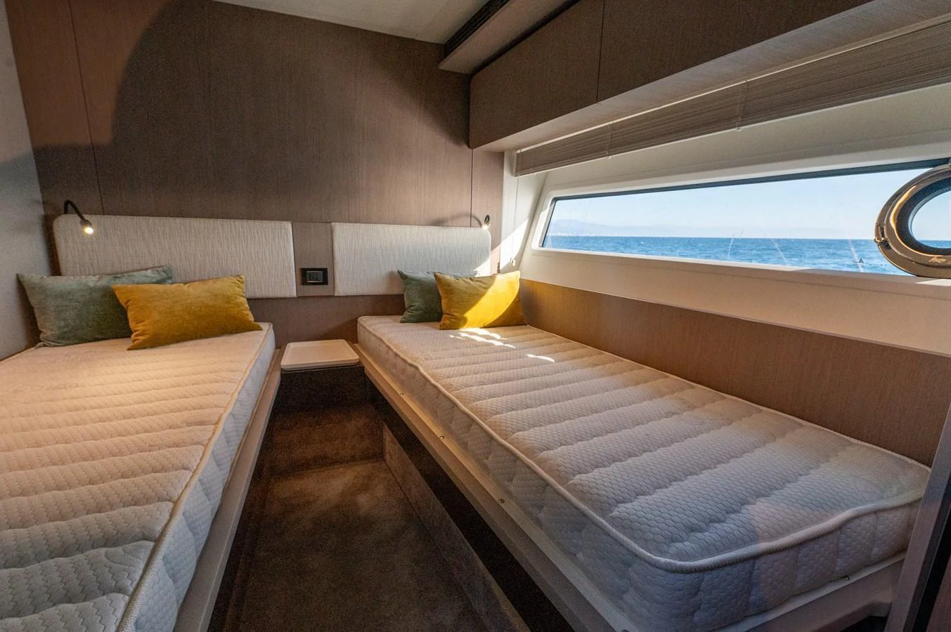 The twin stateroom offers a cozy and inviting space with ample natural light from the large window. aboard HELSIE SI Yacht for Sale