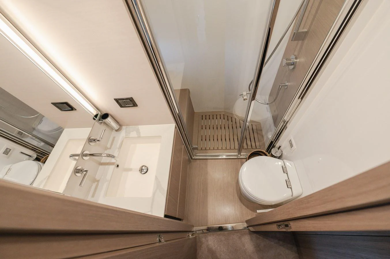 A sleek and modern yacht bathroom with a glass-enclosed shower and contemporary fixtures. aboard HELSIE SI Yacht for Sale