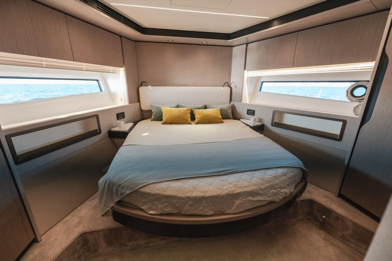 The stateroom features a luxurious bed with modern decor and ample natural light from the windows. aboard HELSIE SI Yacht for Sale