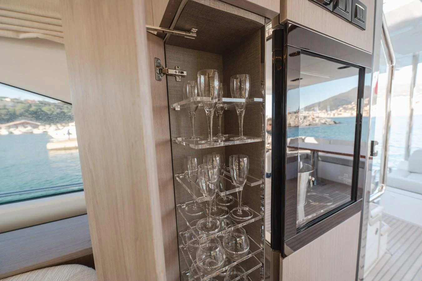 A well-organized glassware cabinet on a yacht, showcasing elegant wine glasses. aboard HELSIE SI Yacht for Sale