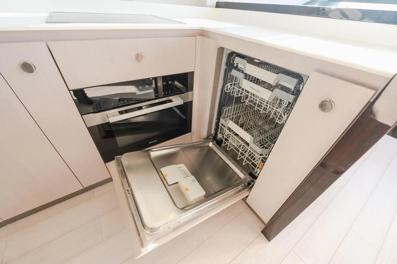 The yacht's galley features modern appliances, including an open dishwasher and sleek cabinetry. aboard HELSIE SI Yacht for Sale