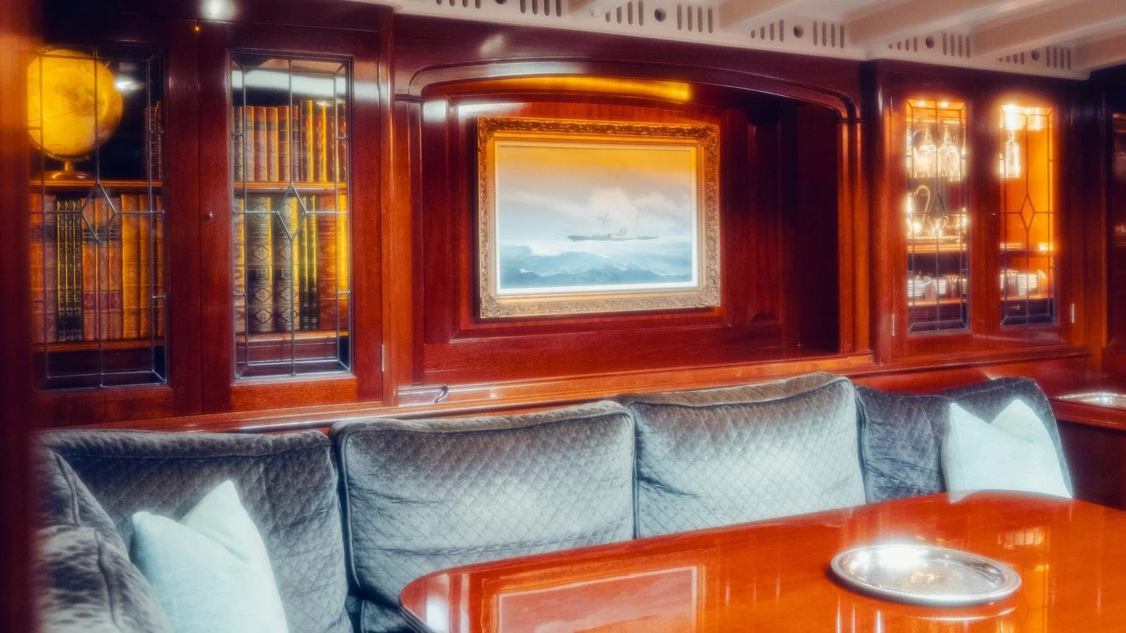 a room with a couch and a table and a painting on the wall aboard SAVANNAH Yacht for Sale