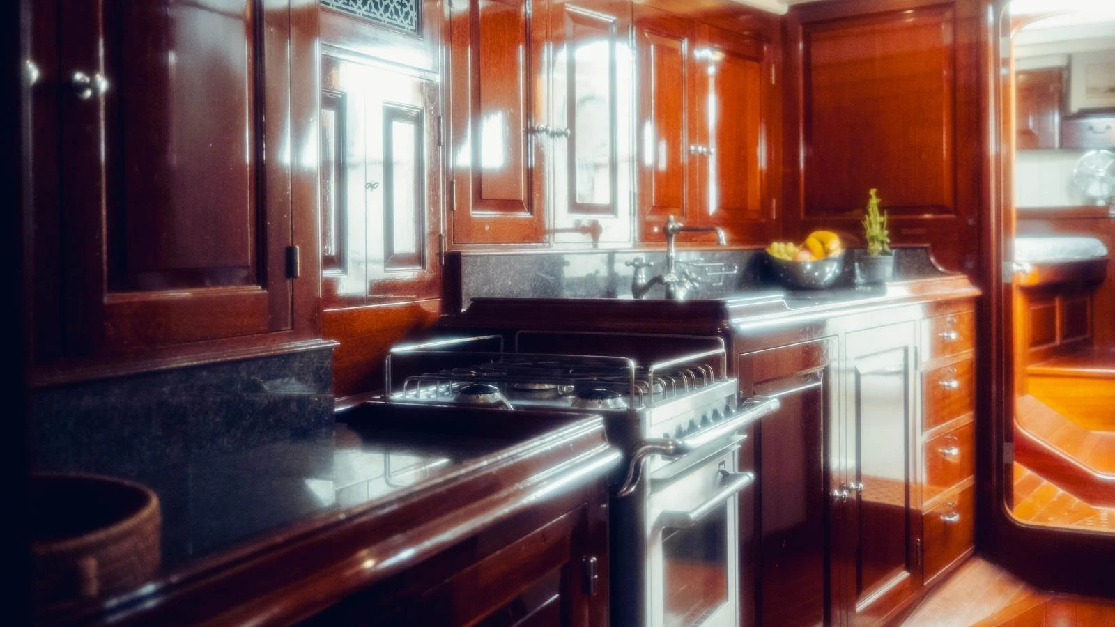 a kitchen with wooden cabinets aboard SAVANNAH Yacht for Sale