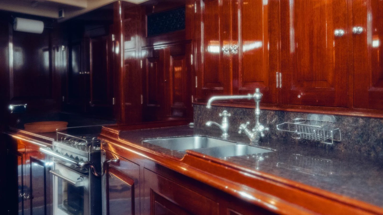 a kitchen with wooden cabinets aboard SAVANNAH Yacht for Sale