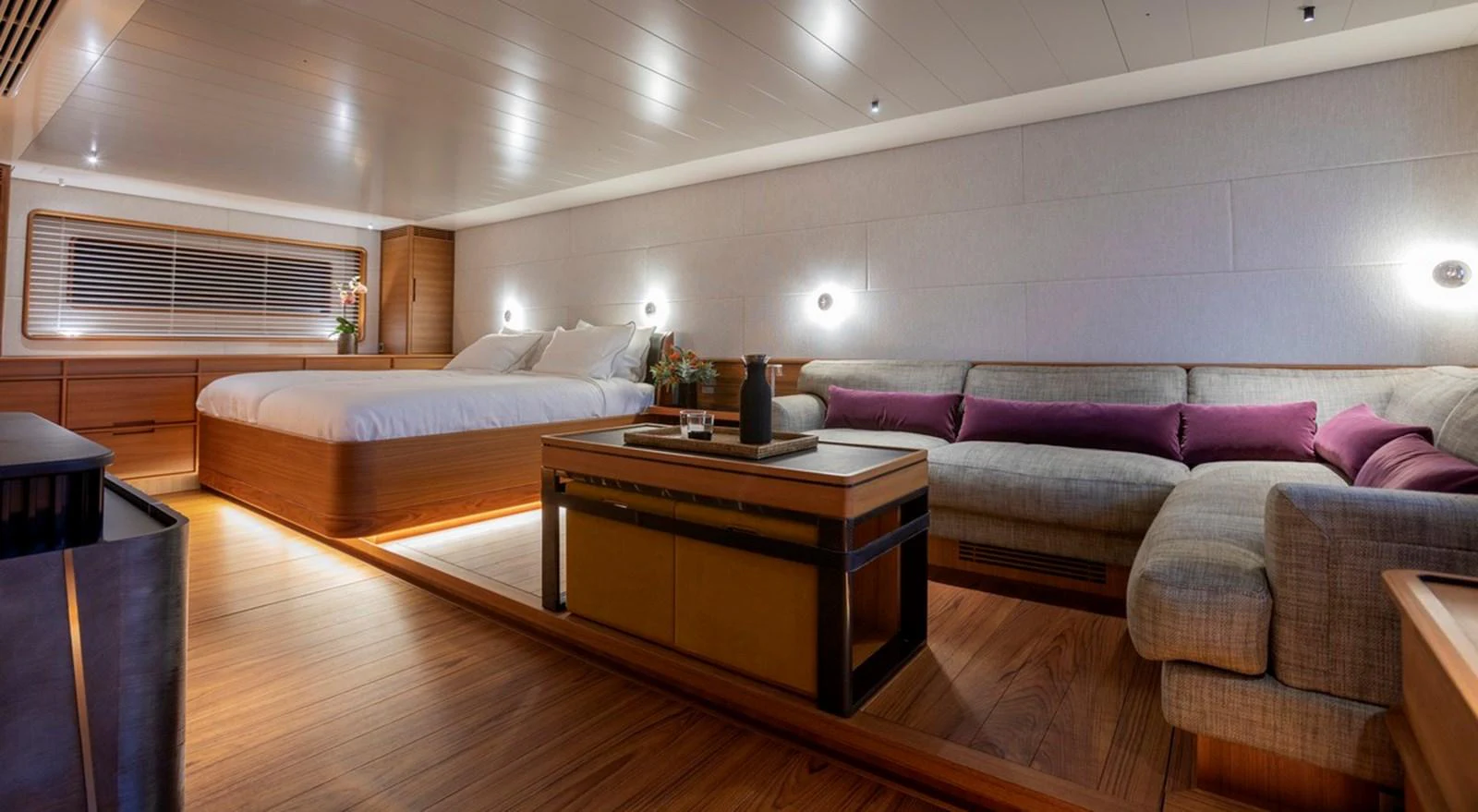 The master stateroom features a spacious bed, cozy seating area, and elegant wooden finishes. aboard CANOVA Yacht for Sale
