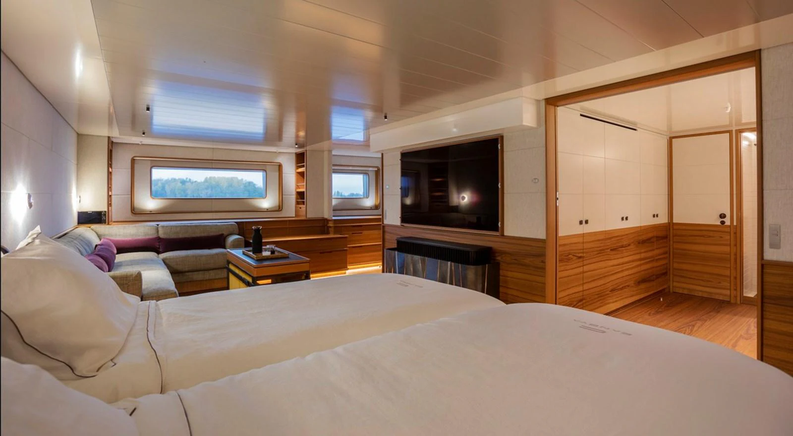 The stateroom features a spacious layout with elegant wood finishes and large windows for natural light. aboard CANOVA Yacht for Sale