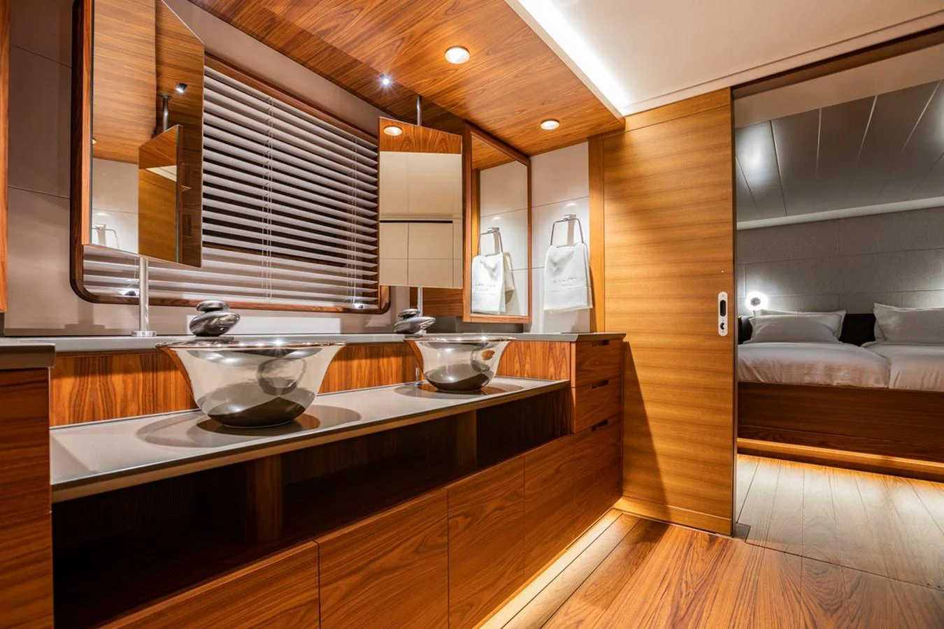 The yacht's bathroom features modern fixtures and luxurious wood finishes. aboard CANOVA Yacht for Sale