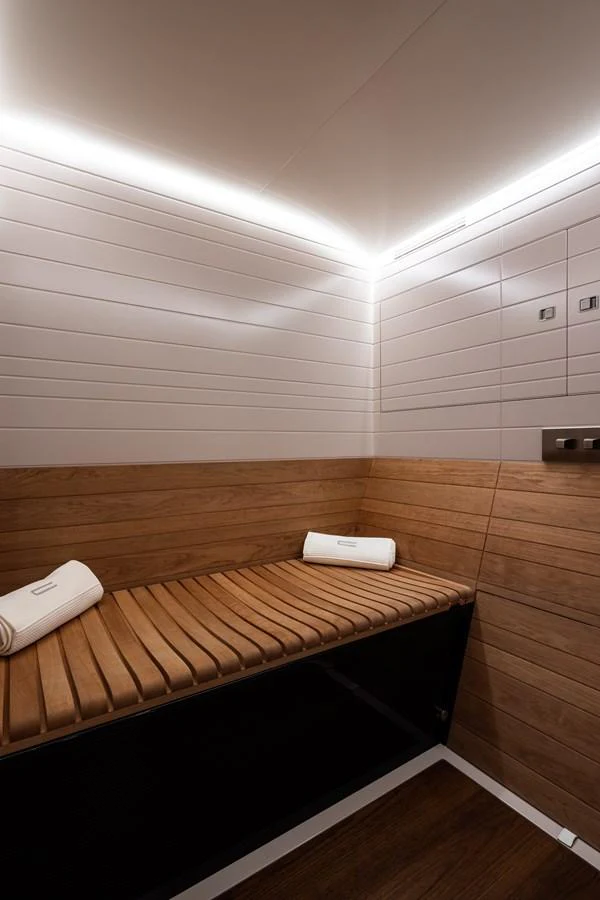 The yacht features a luxurious sauna with wooden benches and ambient lighting. aboard CANOVA Yacht for Sale