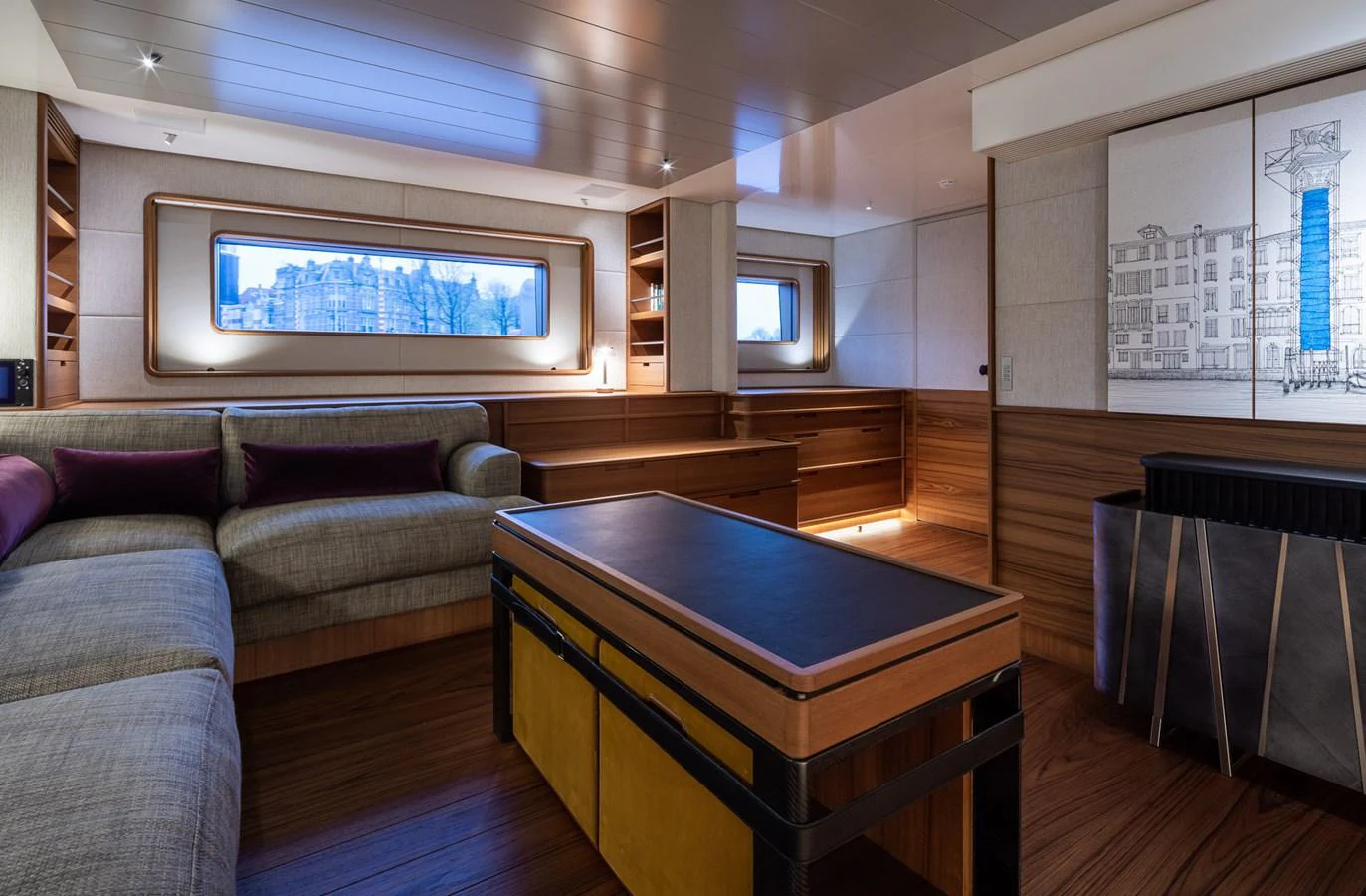The salon features a cozy seating area with a large window offering scenic views. aboard CANOVA Yacht for Sale