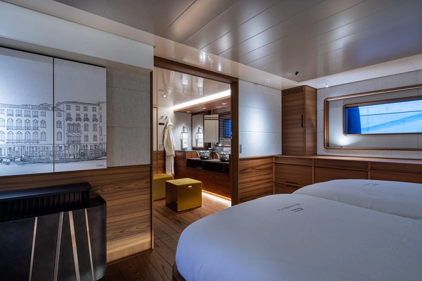 The guest stateroom features twin beds and elegant wood paneling, leading to a well-lit en suite bathroom. aboard CANOVA Yacht for Sale