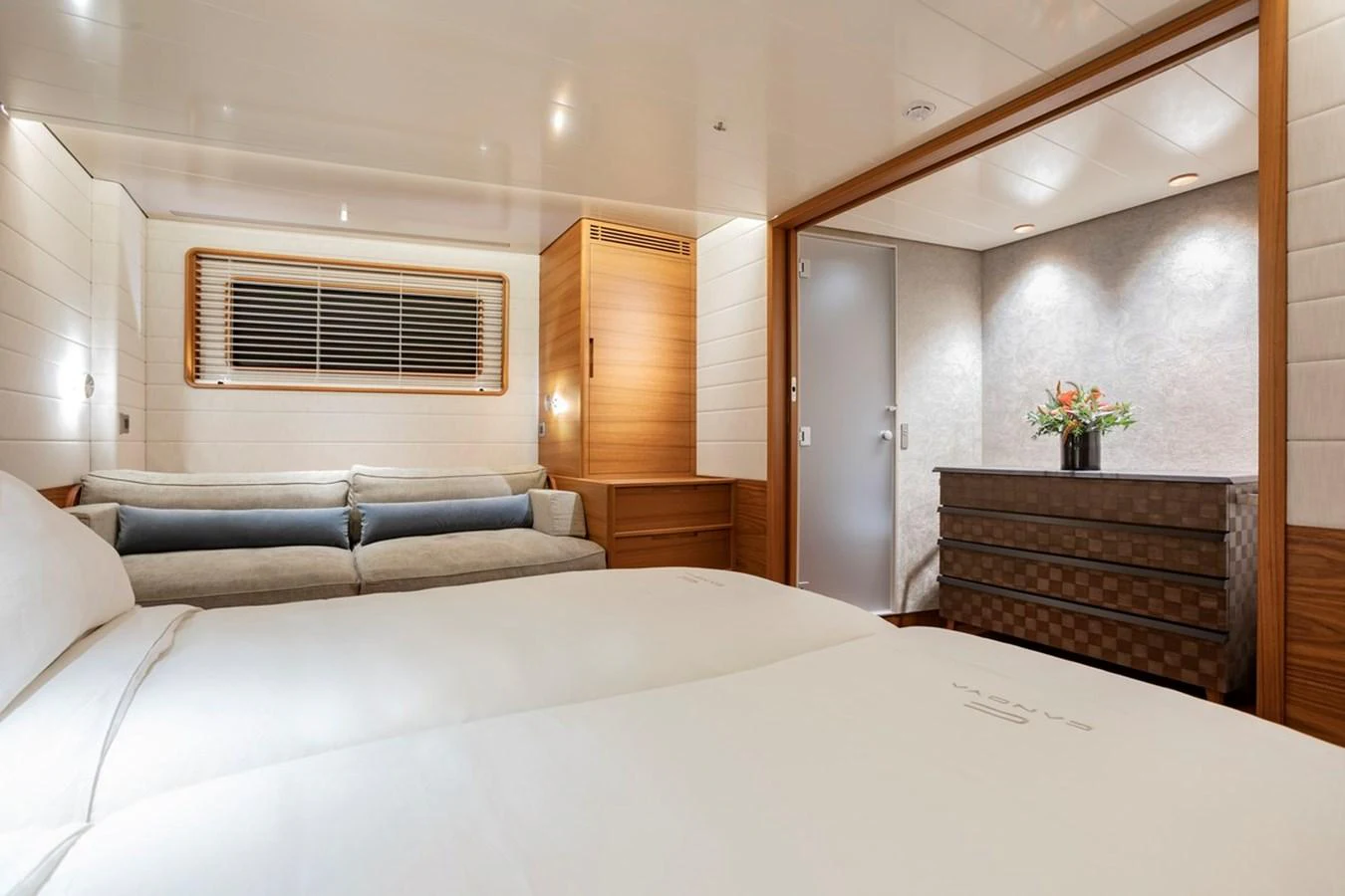 The guest stateroom offers a serene and comfortable space with modern furnishings and soft lighting. aboard CANOVA Yacht for Sale