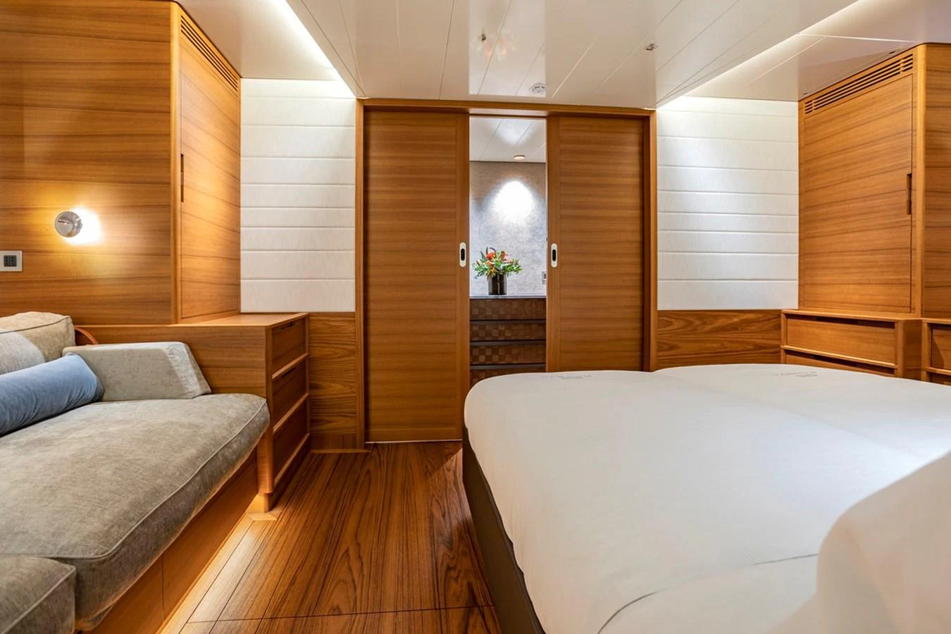 The stateroom features elegant wood paneling and a cozy seating area, creating a warm and inviting atmosphere. aboard CANOVA Yacht for Sale