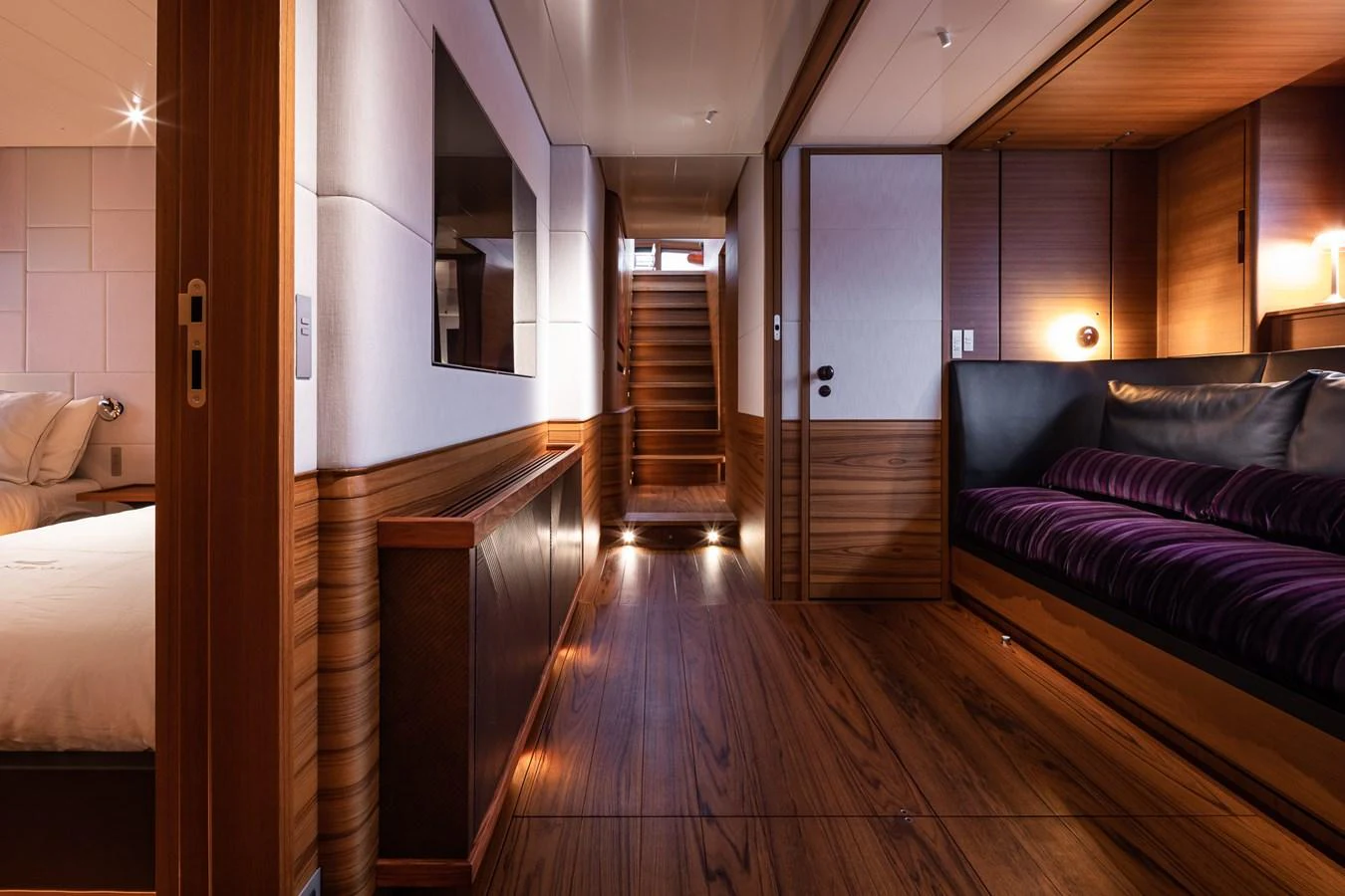 A luxurious hallway featuring rich wood paneling and elegant lighting. aboard CANOVA Yacht for Sale