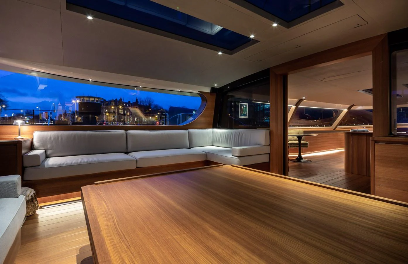 The yacht's salon features a spacious and elegant seating area with panoramic windows and ambient lighting. aboard CANOVA Yacht for Sale