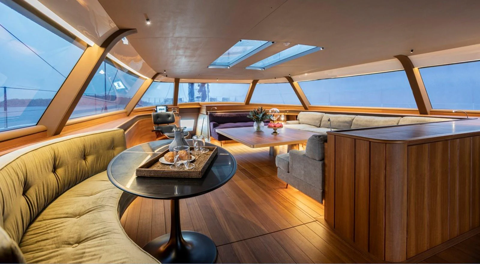 The salon offers a spacious and elegant setting with panoramic windows and luxurious furnishings. aboard CANOVA Yacht for Sale