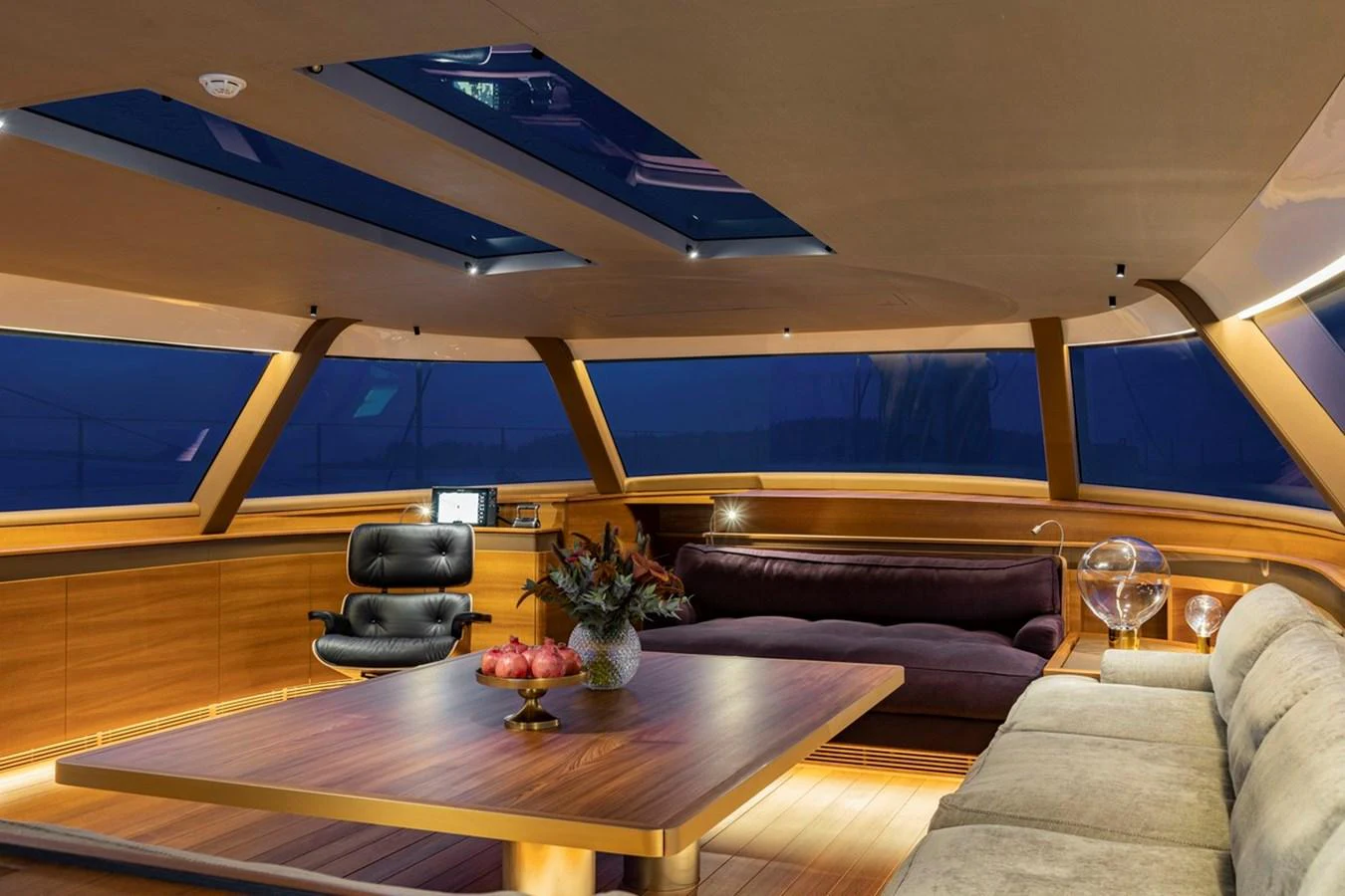 The salon features luxurious seating and a modern design with panoramic windows and a skylight. aboard CANOVA Yacht for Sale