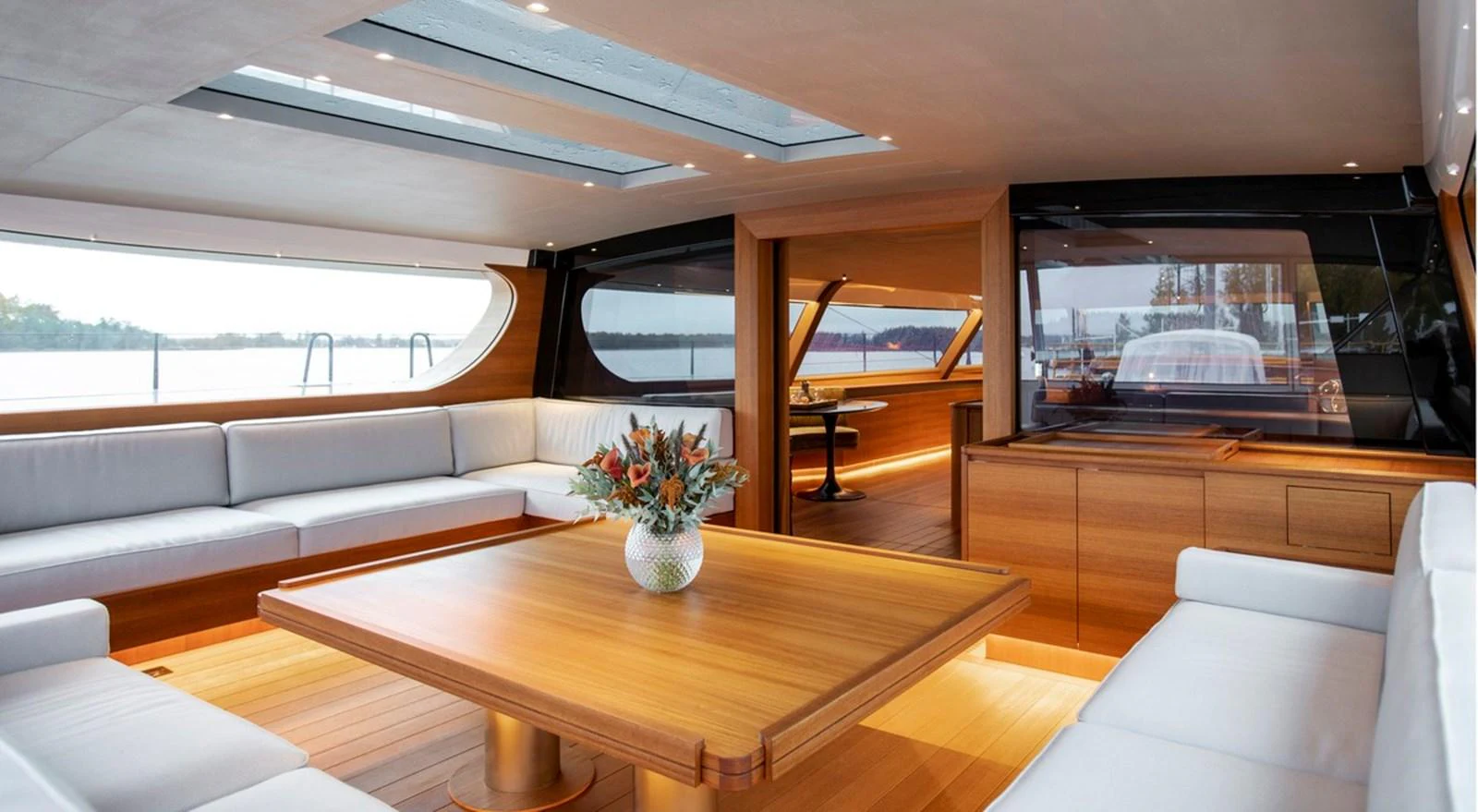 The yacht's salon features elegant wood finishes, ample seating, and large windows offering stunning views. aboard CANOVA Yacht for Sale