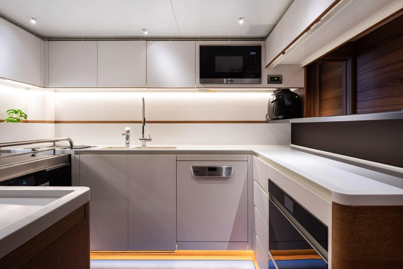 The modern galley features sleek cabinetry, high-end appliances, and ample counter space. aboard CANOVA Yacht for Sale