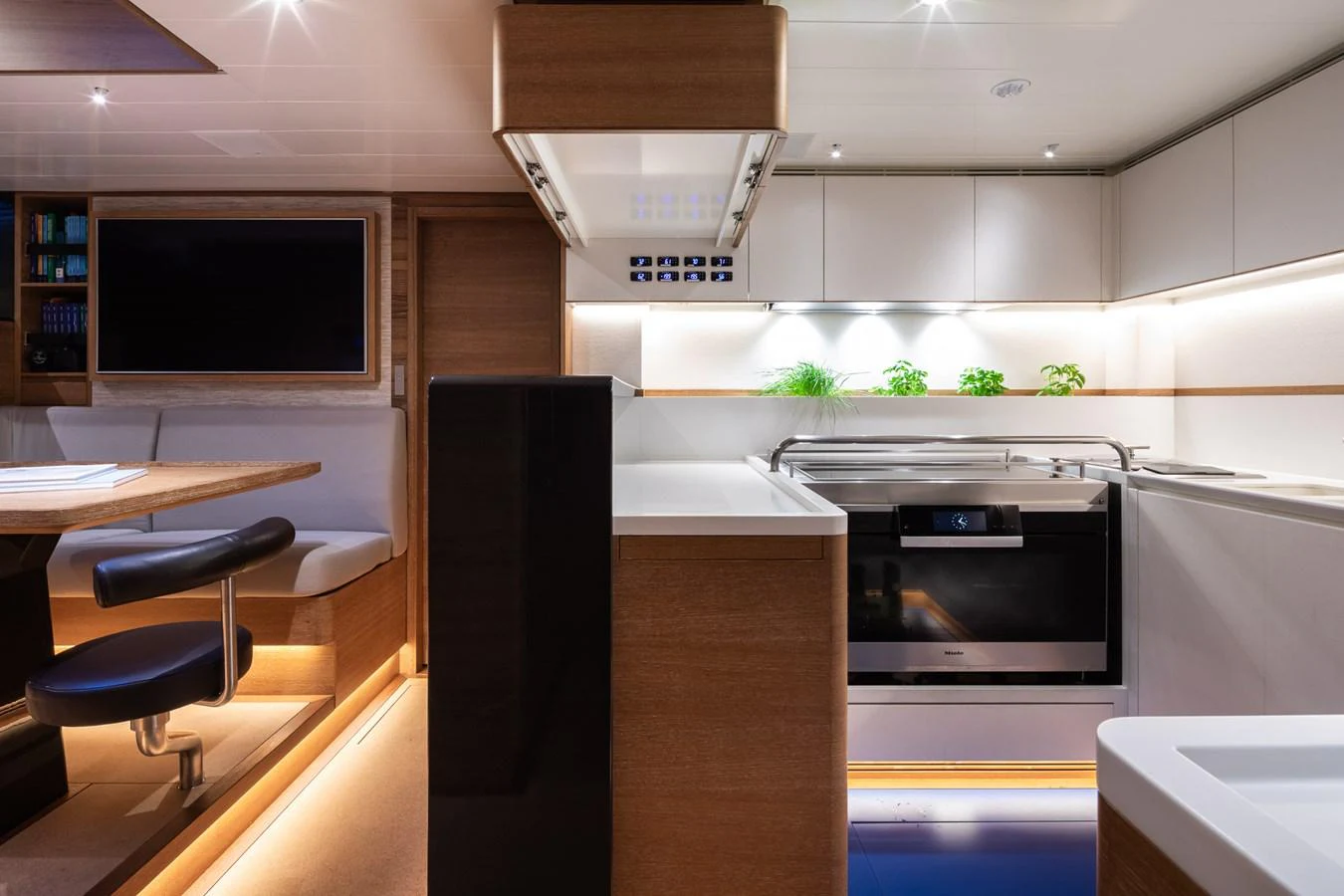 The yacht's galley features modern appliances and sleek design with ample lighting. aboard CANOVA Yacht for Sale