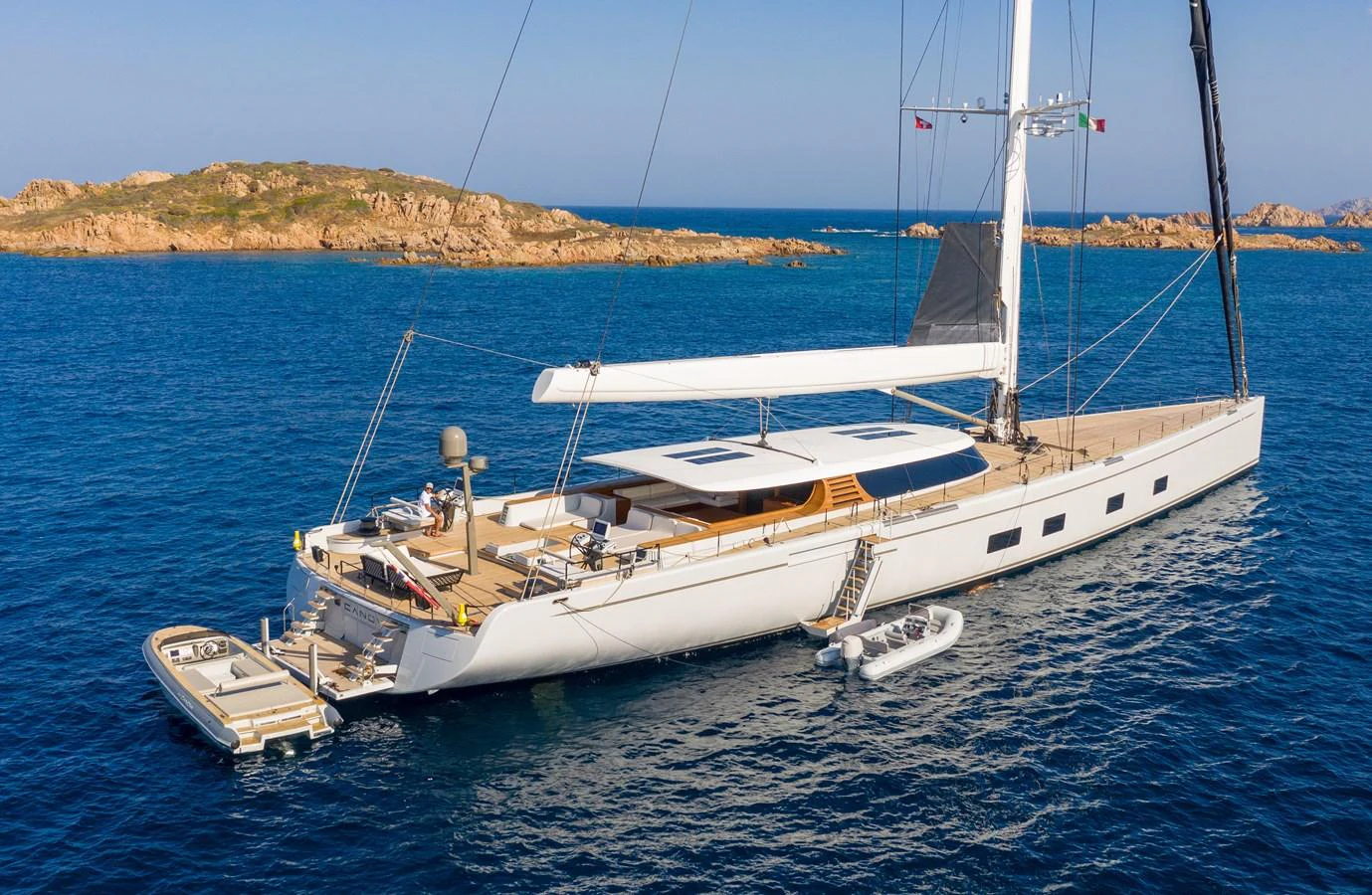 A sleek sailing yacht glides gracefully on the open sea, showcasing its elegant design and spacious deck. aboard CANOVA Yacht for Sale