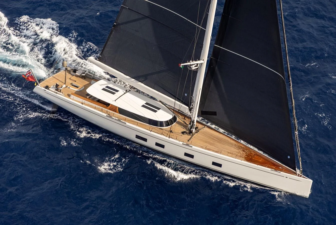 A sleek sailing yacht glides gracefully over the deep blue sea, showcasing its elegant design and powerful sails. aboard CANOVA Yacht for Sale
