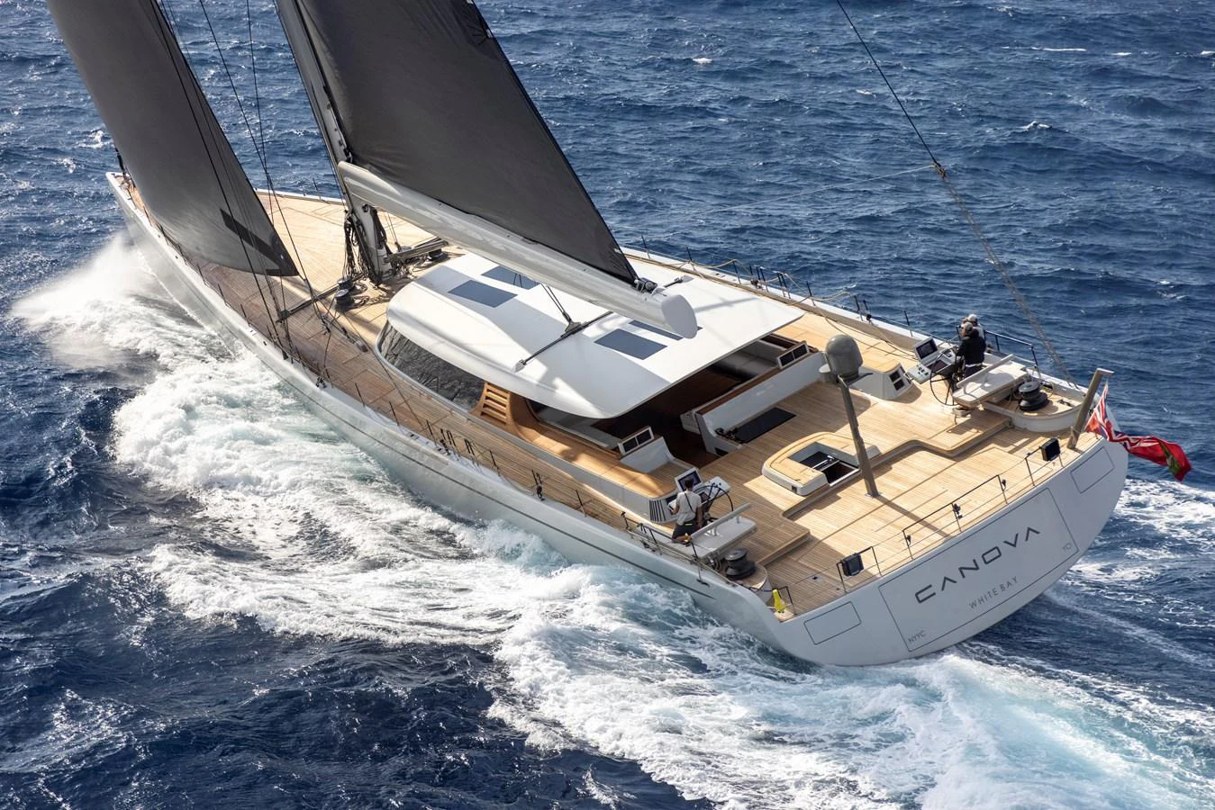 A sleek sailing yacht glides through the open sea with its sails catching the wind. aboard CANOVA Yacht for Sale