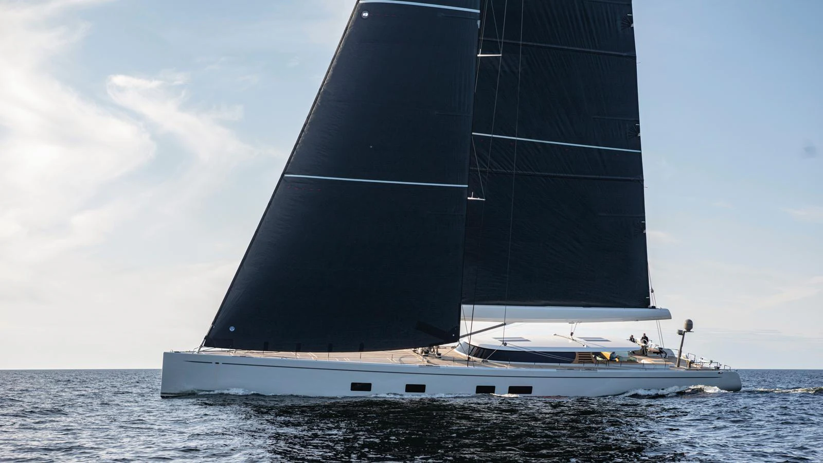A sleek sailing yacht glides gracefully on the open water under a clear sky. aboard CANOVA Yacht for Sale