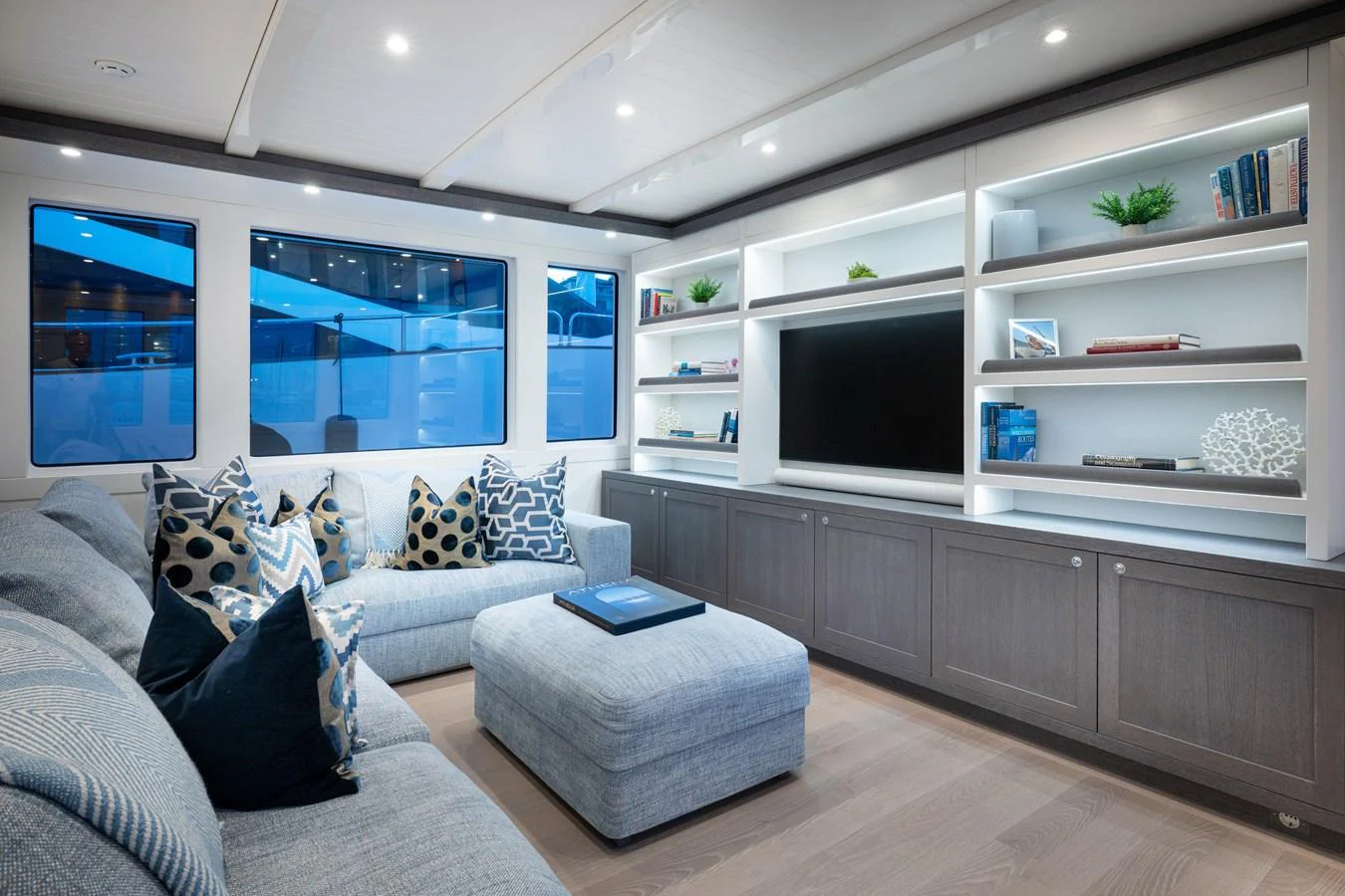 a living room with a large white shelf and a grey couch aboard FAR NIENTE Yacht for Sale