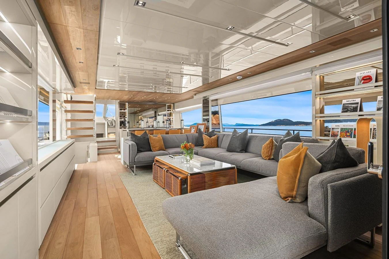 The spacious salon features modern furnishings and large windows offering stunning sea views. aboard ESSENZA Yacht for Sale