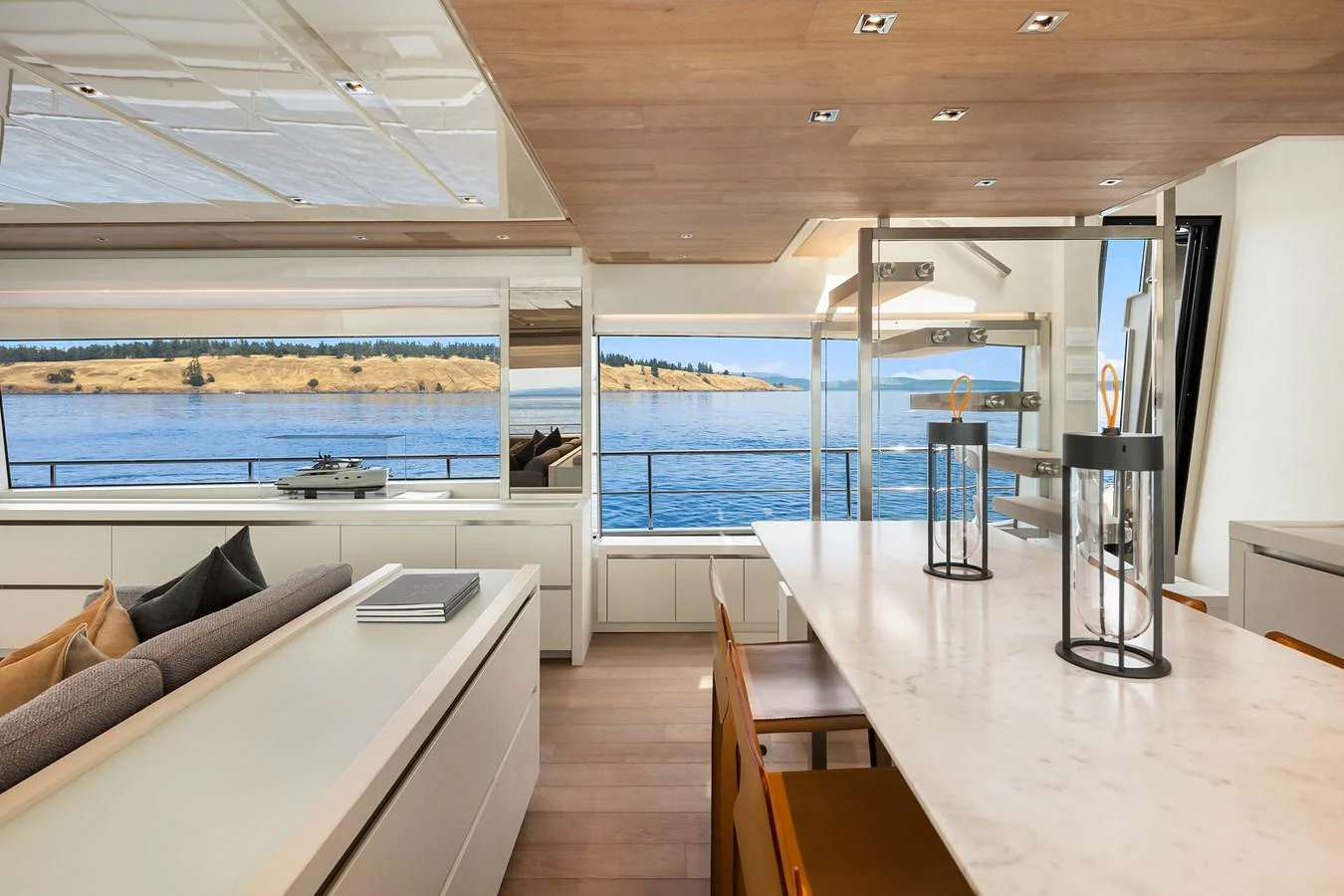 The yacht's salon features a modern and spacious design with large windows offering stunning water views. aboard ESSENZA Yacht for Sale