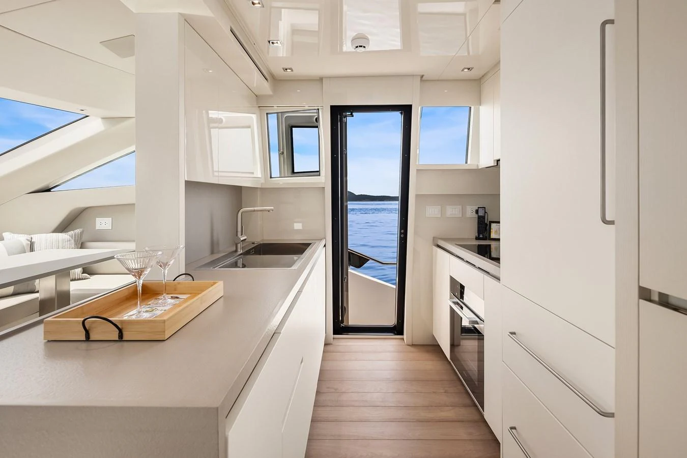The yacht's galley features modern appliances and a sleek design with a view of the water. aboard ESSENZA Yacht for Sale
