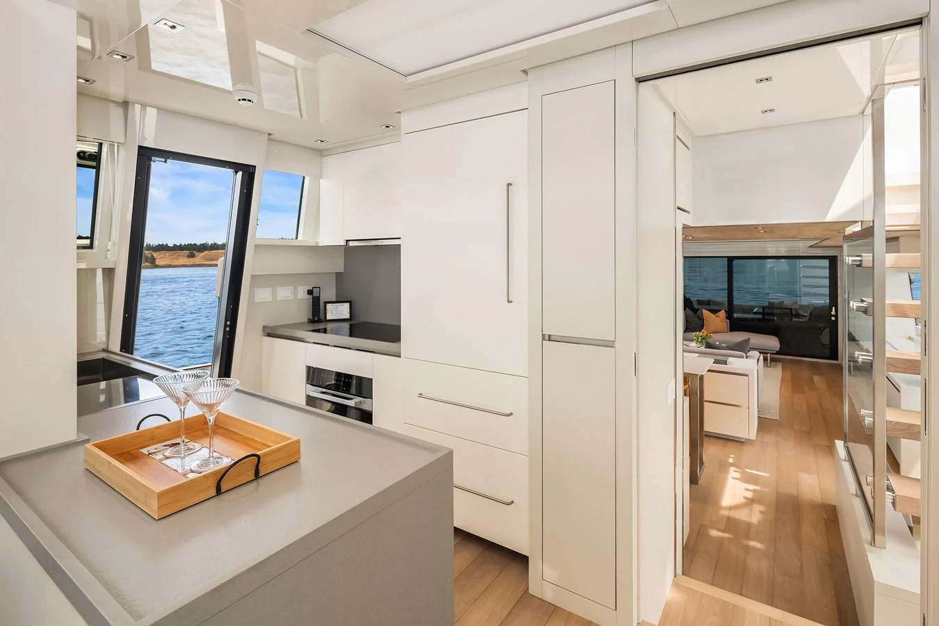 The yacht's galley features modern appliances and sleek cabinetry, seamlessly blending with the open living space. aboard ESSENZA Yacht for Sale