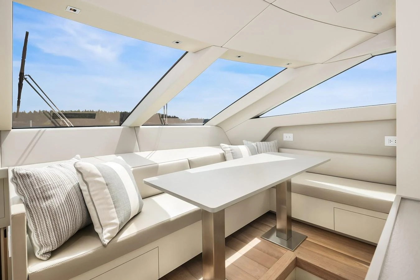 The salon features a sleek, modern design with ample natural light and comfortable seating. aboard ESSENZA Yacht for Sale