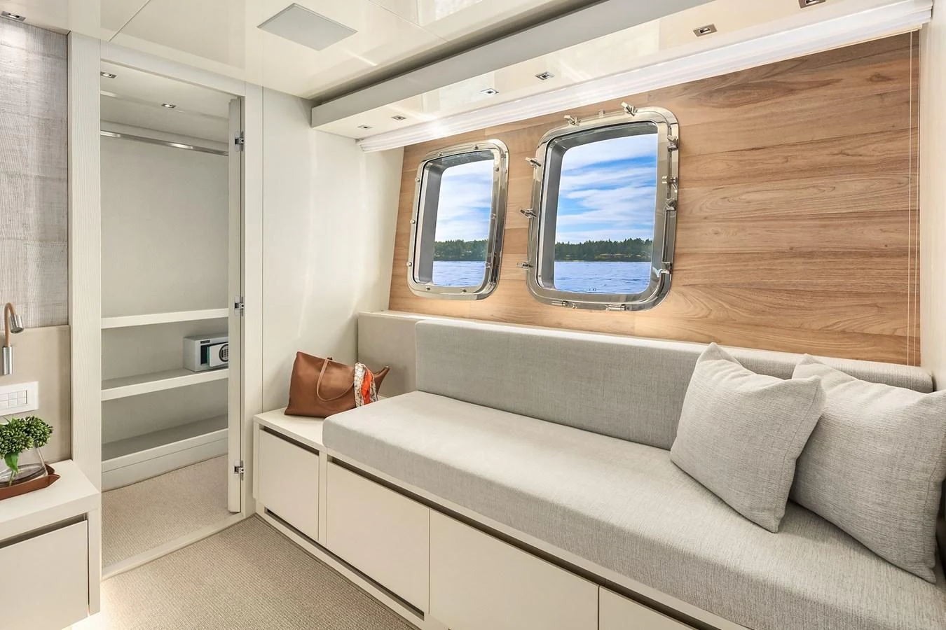 A serene and stylish interior lounge area with large windows offering a view of the sea. aboard ESSENZA Yacht for Sale