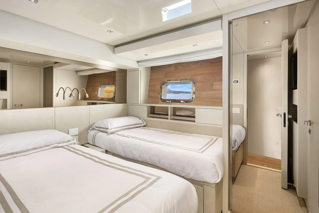 The guest stateroom features twin beds and a modern, elegant design with ample natural light. aboard ESSENZA Yacht for Sale